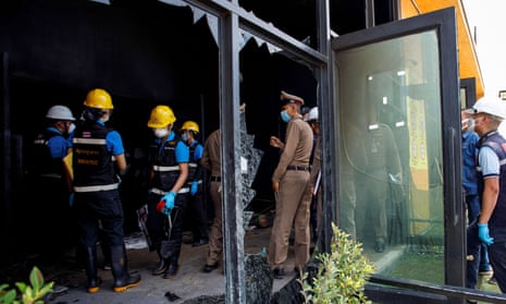 Police and other officials at the Mountain B nightclub in Sattahip district after a fire which killed at least 14 people.