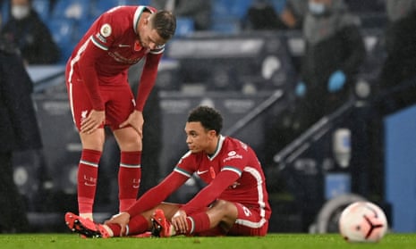 Jordan Henderson consoles Trent Alexander-Arnold after the Liverpool defender collapsed on the ground with a suspected muscle problem. 