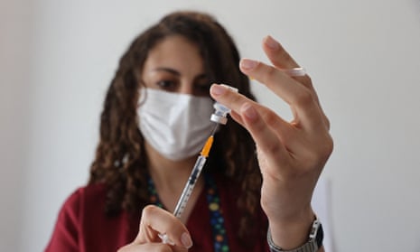 A nurse prepares to administer a dose of the Pfizer-BioNTech vaccine. 