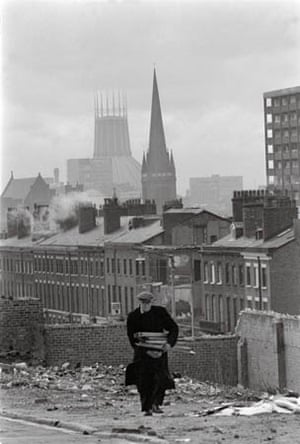 A man collects firewood from derelict buildings in Liverpool, 1978