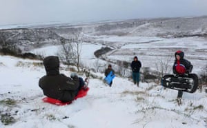 Children play in the snow at the Hole-of-Horcum in the North Yorkshire Moors National Park