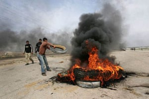 Erez Crossing, Gaza Strip: Young Palestinian protesters burn tyres