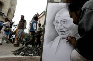 An artist draws a portrait of Gandhi