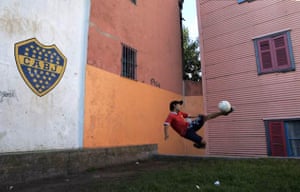 A boy plays soccer at La Boca neighborhood in Buenos Aires