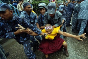 Kathmandu, Nepal: Policemen detain a Tibetan activist during a demonstration in front of the Chinese Embassy