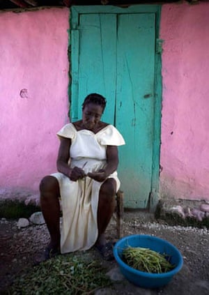 Grantier, Haiti: A woman cleans vegetables outside her home