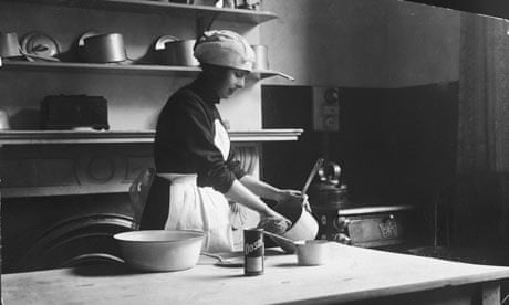 Charwoman scrubbing pots in the 1920s