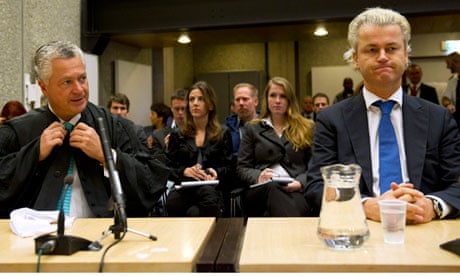 Dutch politician Geert Wilders sitting in court in Amsterdam with his lawyer Bram Moszkowicz
