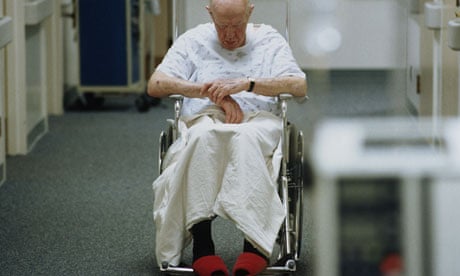 Elderly patient in a wheelchair on a hospital ward