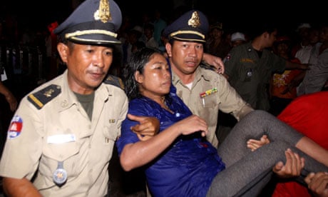 An injured visitor is carried by Cambodian police
