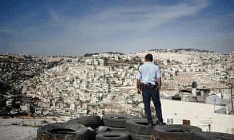 An Israeli policeman stands guard on the