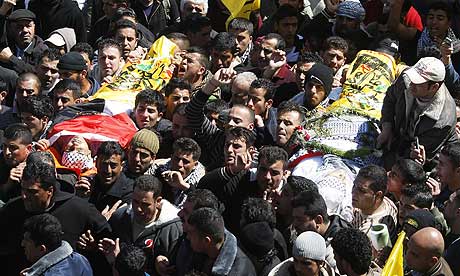 Palestinian mourners carry the bodies of Mohammad Qadus and Osaid Qadus.