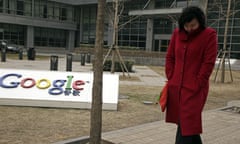 A Chinese woman walks past the Google logo at the Google China headquarters in Beijing, China