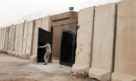 Iraqi soldier closes gate at a Baghdad prison