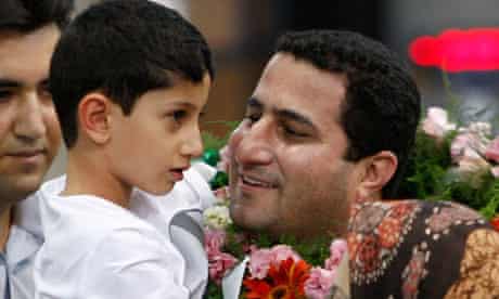 Shahram Amiri carrying his son 