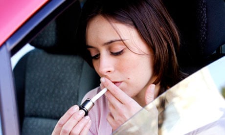 A women smoking inside a car