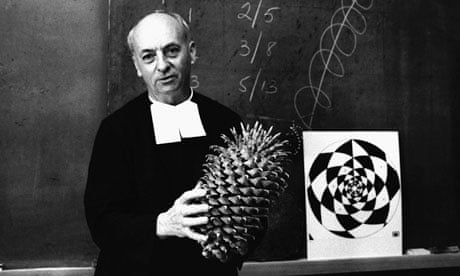Brother Brousseau uses a large pine cone to demonstrate the Fibonacci principle of mathematics