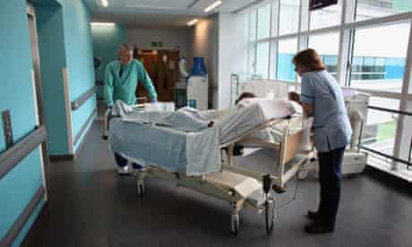 Staff look after patient on trolly in Queen Elizabeth Hospital 