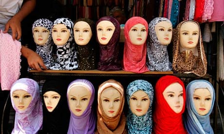 Jordanian vendor arranges headscarves for sale, in downtown Amman