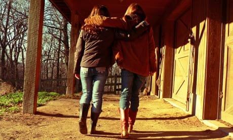 Best friends walking with arms around each other 