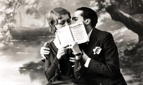 romantic couple kissing behind an open book