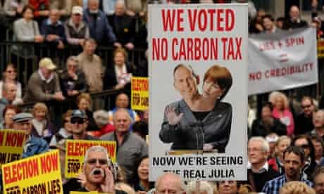 Protesters hold placards during a rally in Sydney against carbon tax