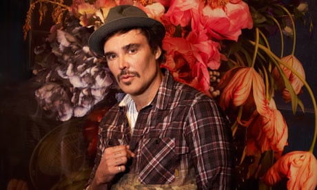 David LaChapelle photographed with one of his works at the Robilant + Voena Gallery, London