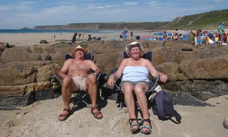 couple sunbathing on British beach
