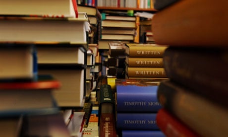 piles of hardback books in a bookshop