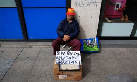 Unemployed Juan Bayes, 60, sleeps as he begs in the Andalusian capital of Seville.