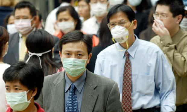 People wear masks on the streets of Hong Kong following the outbreak of Sars, March 2003.