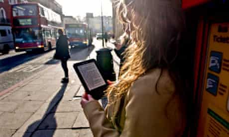 A woman with an e-reader on a London street