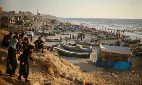 Palestinians enjoy the weather on the beach in Gaza City