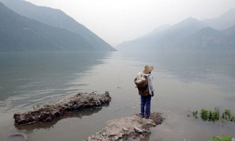 Han Xianzhong, a 70-year-old man, stands at the site of his dismantled house in the Three Gorges area, June 2003