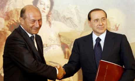 Traian Basescu and Silvio Berlusconi shake hands after a joint press conference at Chigi Palace