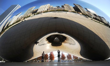 People admire Cloud Gate by British artist Anish Kapoor at the AT&T Plaza in Millennium Park that reflects the downtown skyline in Chicago, Illinois