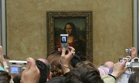 Mona Lisa at the Louvre with tourist photographers.