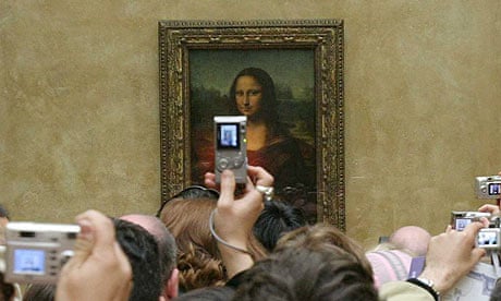 Mona Lisa at the Louvre with tourist photographers.