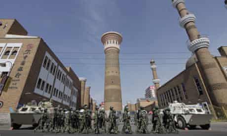 Security forces on patrol near a mosque in Urumqi.