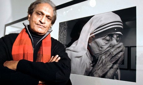 Raghu Rai poses next to his photograph of Mother Teresa in Madrid