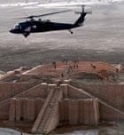 A US army helicopter flies over the stepped Ziggurat temple