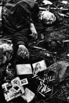 A dead North Vietnamese soldier and his plundered belongings, Hue, 1968
