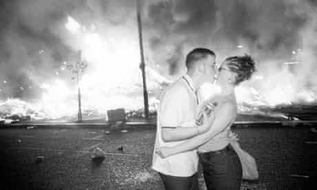 A couple kissing during the July 14th bonfire night demonstrations in the Sandy Road area of Belfast