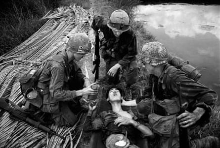 American G.I's showing compassion toward an injured Vietcong soldier