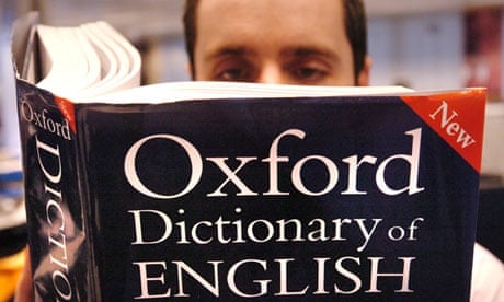 A man reads a copy of the Oxford English Dictionary