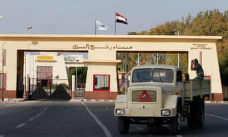 Egyptian military truck passes in front of Rafah border crossing gate in Al Arish