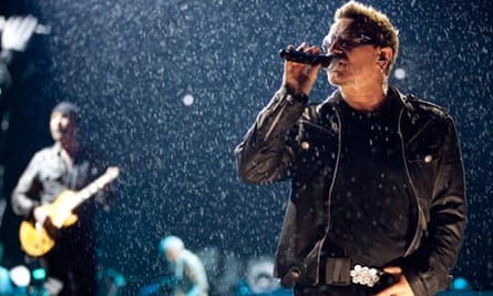 U2's Bono on stage in the raing at Glastonbury 2011