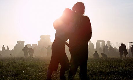 Sunrise at Stonehenge as people gather to celebrate the summer solstice.
