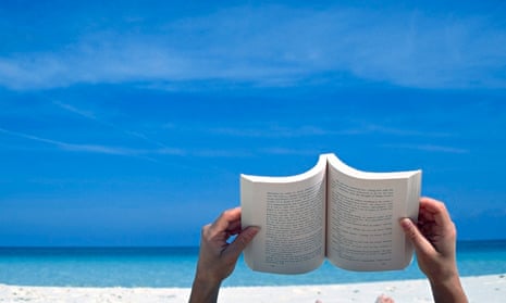Person reading a book on the beach