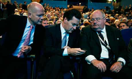 William Hague, George Osborne and Eric Pickles consult a Blackberry
